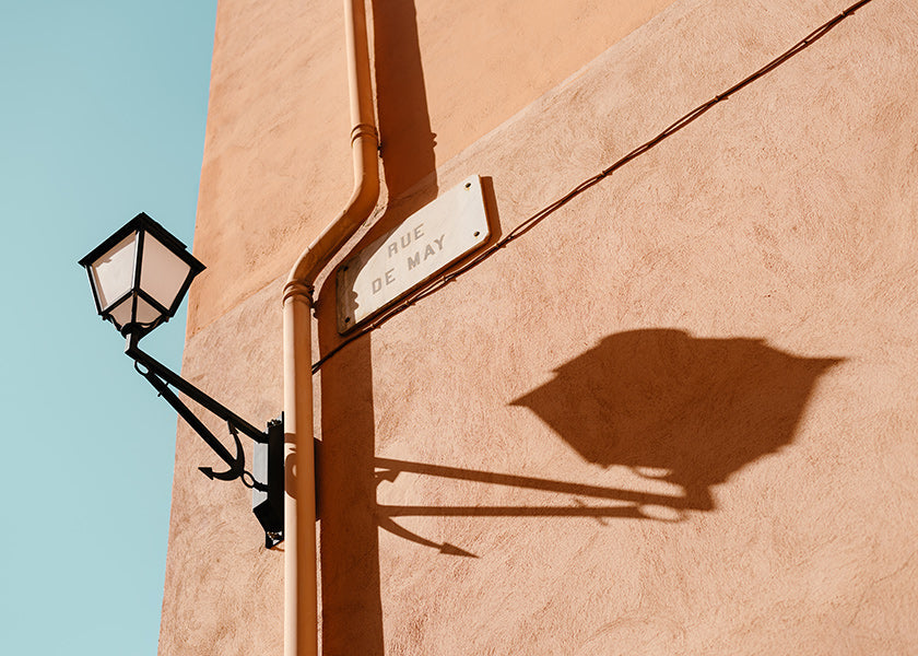 Travel poster with Rue de May lamp and shadow