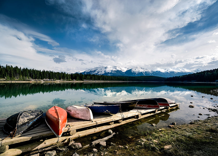 Landscape art: canoes on a wooden jetty