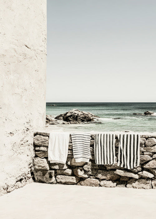 Coastal landscape photograph with hanging towels